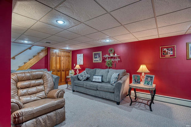 living room with carpet, a paneled ceiling, and a baseboard heating unit