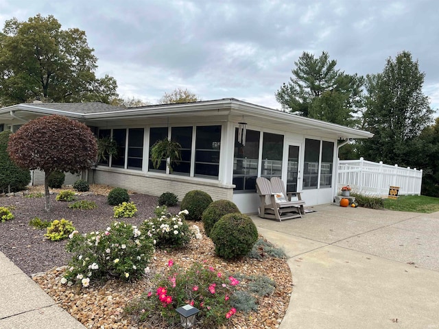 back of property with a sunroom