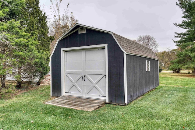 view of outdoor structure featuring a lawn