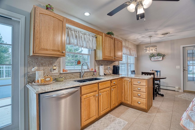 kitchen featuring a wealth of natural light, dishwasher, hanging light fixtures, and sink