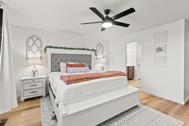 bedroom with ceiling fan, light hardwood / wood-style floors, and ensuite bathroom