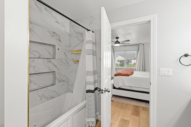 bathroom featuring shower / bath combo, a textured ceiling, hardwood / wood-style flooring, and ceiling fan