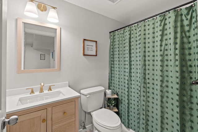 bathroom featuring walk in shower, vanity, and toilet