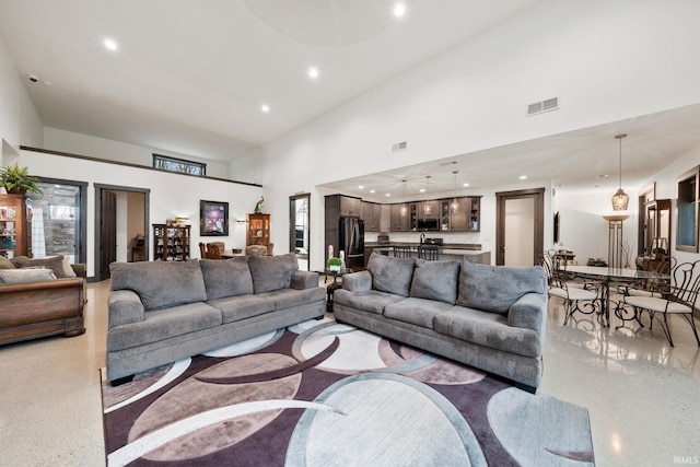 living room with a towering ceiling