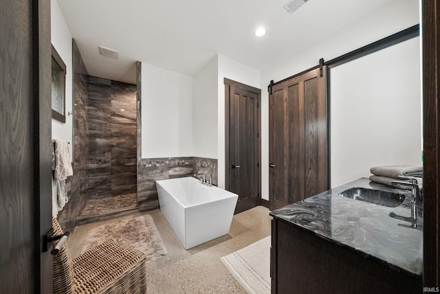 bathroom featuring vanity, shower with separate bathtub, and tile walls