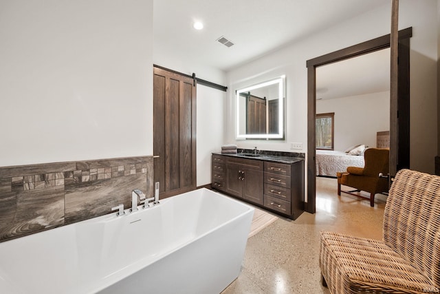 bathroom with a bathing tub and vanity