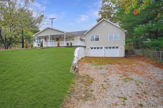 view of front facade with a garage, a porch, and a front lawn