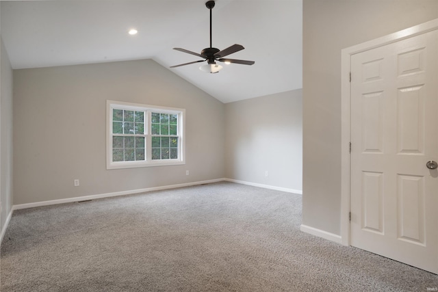 empty room featuring ceiling fan, carpet flooring, and vaulted ceiling