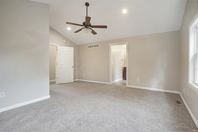 carpeted empty room with high vaulted ceiling and ceiling fan