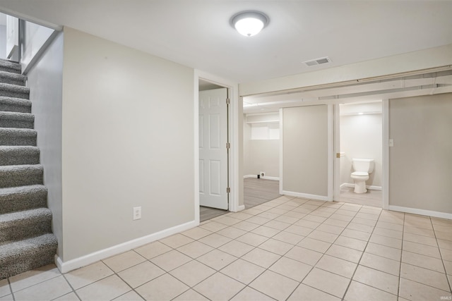 basement featuring light tile patterned floors