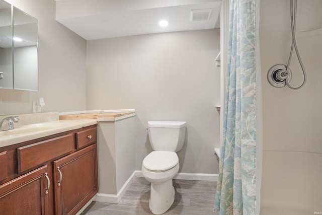 bathroom featuring a shower with shower curtain, wood-type flooring, vanity, and toilet