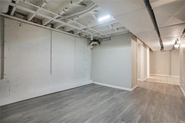 basement with hardwood / wood-style flooring