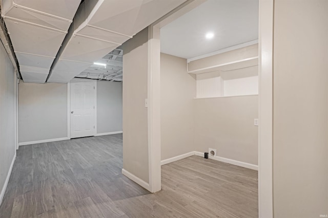 basement with hardwood / wood-style floors