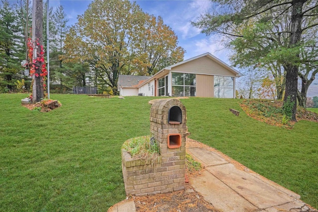 view of front of home with a front lawn and a sunroom