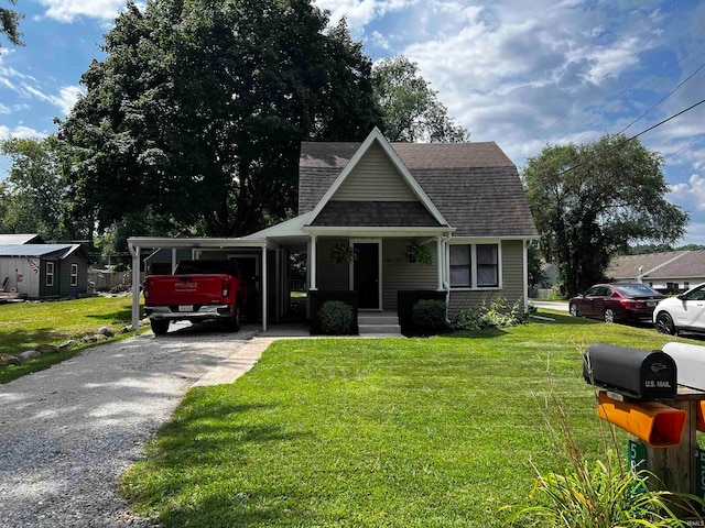 bungalow-style house with a front yard and a carport