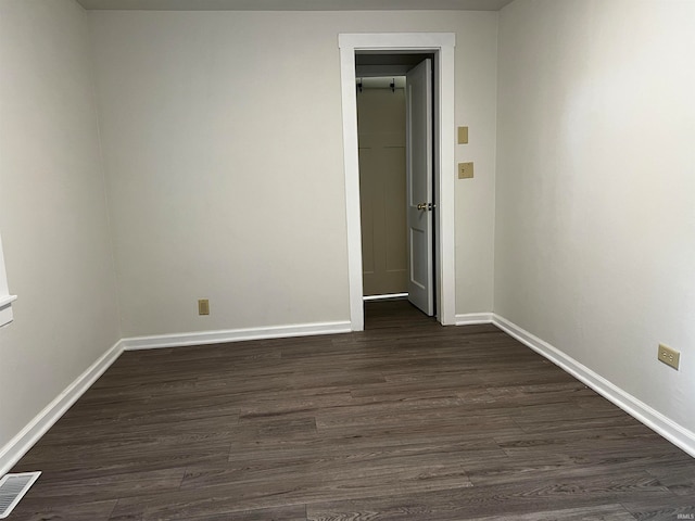 spare room with dark hardwood / wood-style flooring