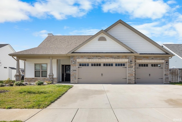 craftsman-style house featuring a garage and a front lawn