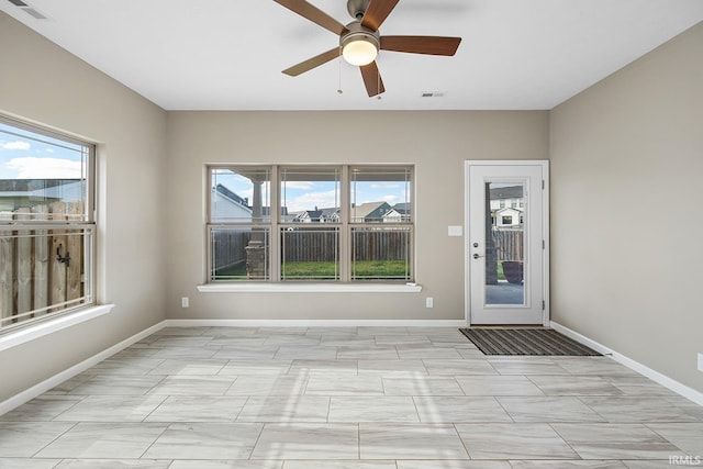 interior space with ceiling fan