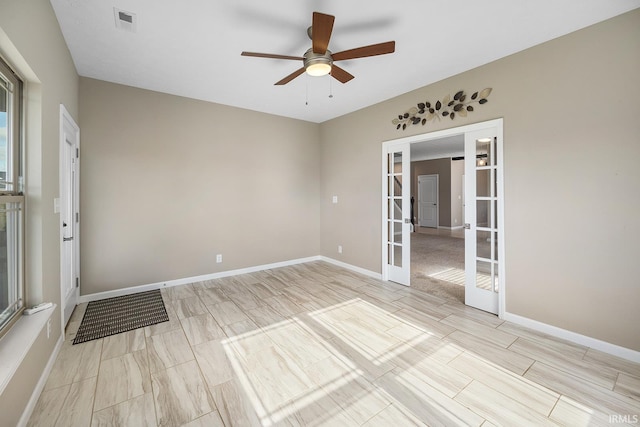 unfurnished room featuring french doors and ceiling fan