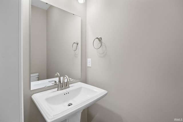 bathroom featuring sink and toilet