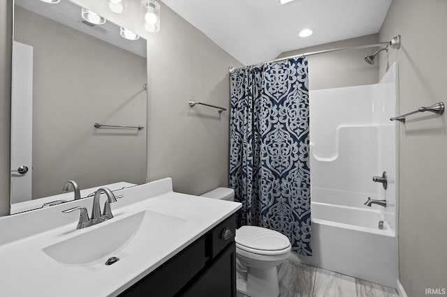 full bathroom with vanity, toilet, and shower / tub combo