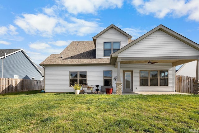 back of property featuring a lawn and a patio