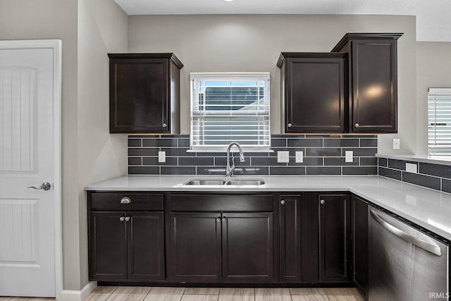 kitchen featuring a healthy amount of sunlight, sink, decorative backsplash, and dishwasher