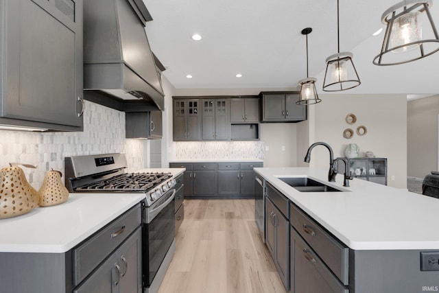 11903 Cross Winds Way, Fort Wayne, IN 46818 - kitchen with appliances with stainless steel finishes, wall chimney exhaust hood, light wood-style floors, light countertops, and tasteful backsplash