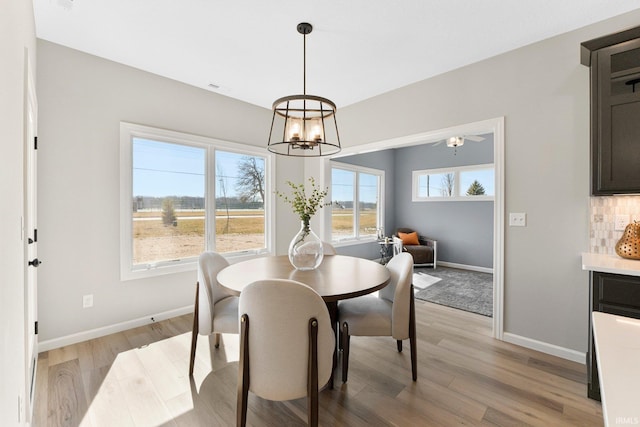 11903 Cross Winds Way, Fort Wayne, IN 46818 - dining area with a chandelier and light wood-style flooring