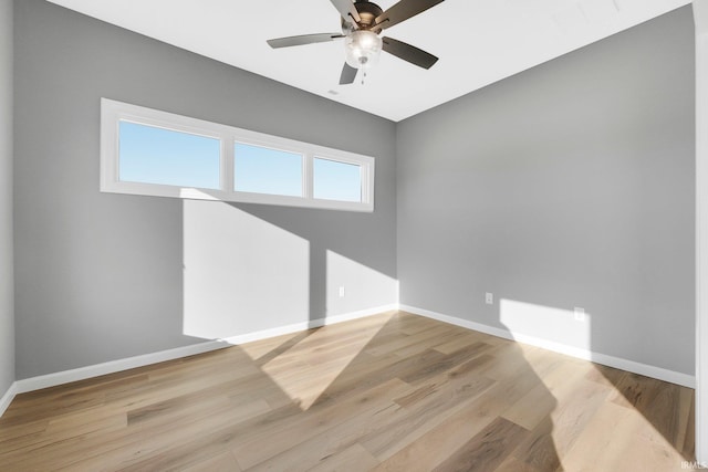 spare room featuring light hardwood / wood-style flooring and ceiling fan