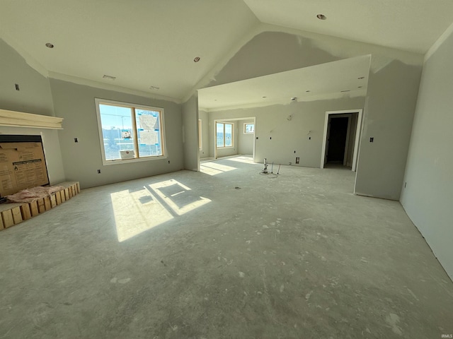 unfurnished living room featuring high vaulted ceiling