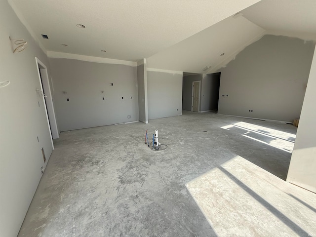 unfurnished living room with lofted ceiling