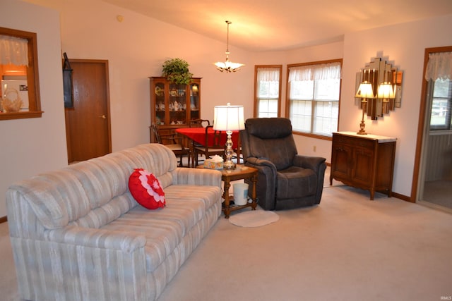 carpeted living room featuring a notable chandelier