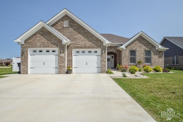 view of front of home with a garage and a front lawn