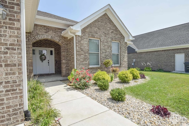 doorway to property featuring a lawn