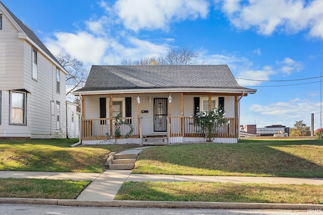 bungalow-style home with a porch and a front lawn