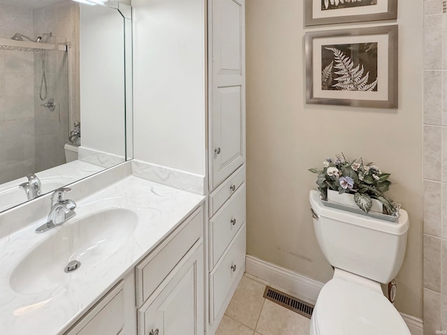 bathroom featuring vanity, a shower with shower door, tile patterned floors, and toilet