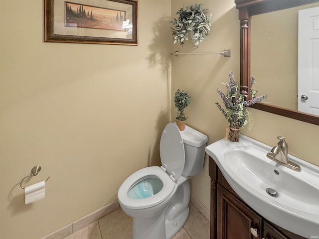 bathroom featuring tile patterned flooring, vanity, and toilet