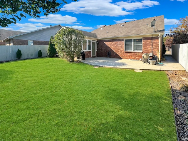 back of house with a patio and a yard