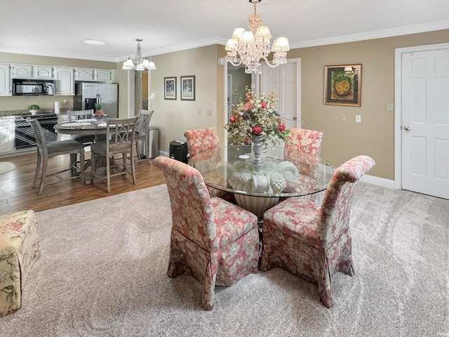 dining space with hardwood / wood-style floors, a chandelier, and crown molding