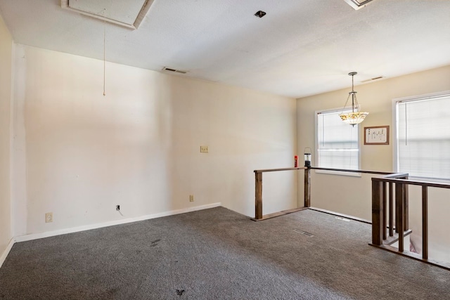 carpeted spare room featuring a textured ceiling