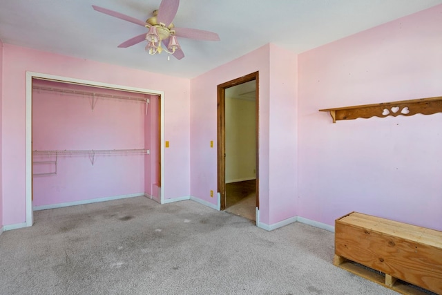 unfurnished bedroom with ceiling fan, light carpet, and a closet