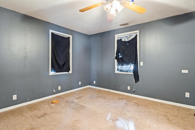 spare room featuring carpet, a textured ceiling, and ceiling fan