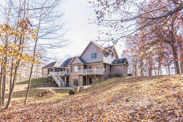 rear view of house featuring a deck