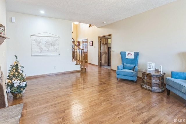 sitting room with a textured ceiling and light wood-type flooring