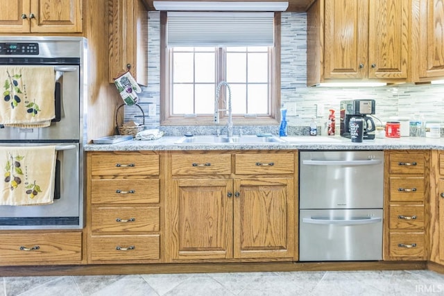 kitchen featuring backsplash, appliances with stainless steel finishes, and sink