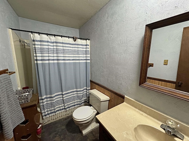 bathroom featuring vanity, a textured ceiling, toilet, and a shower with shower curtain