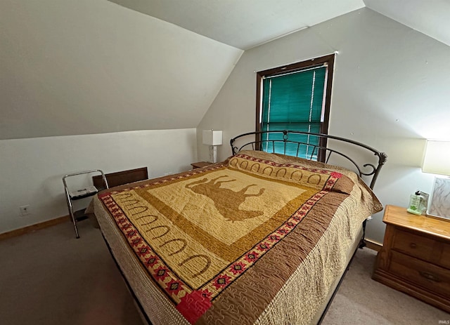 carpeted bedroom featuring lofted ceiling