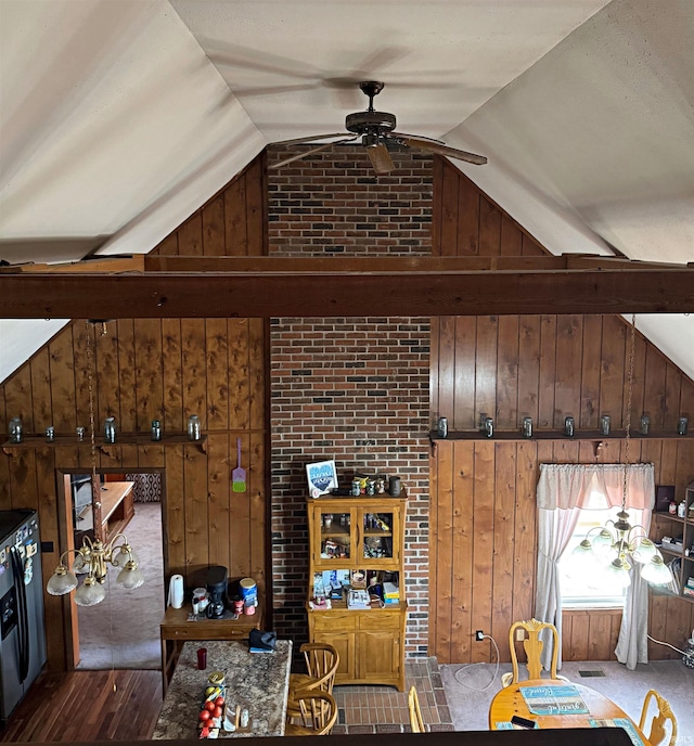 living room featuring wood walls, ceiling fan, vaulted ceiling, and wood-type flooring