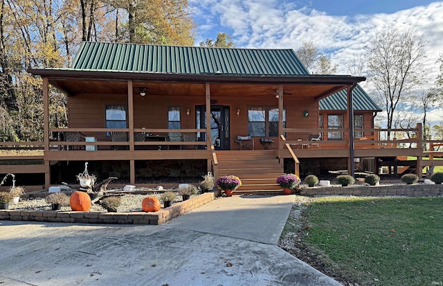 back of house with a wooden deck and a yard